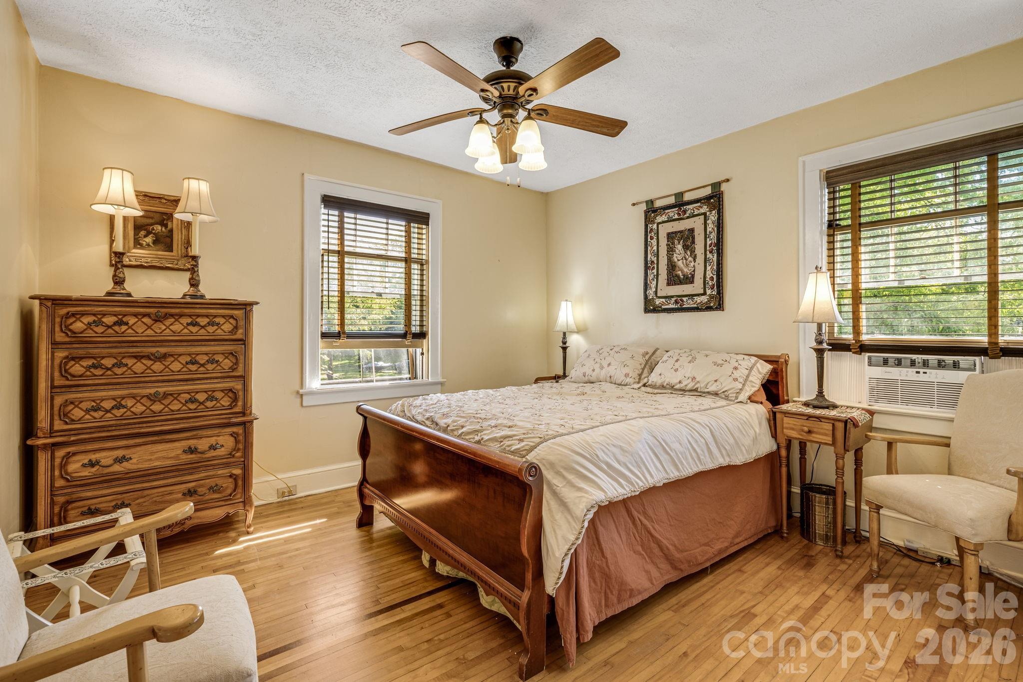 29 Walnut Street Hot Springs, NC 28743 - Photo 24 of 46 a bedroom with a bed and a chandelier