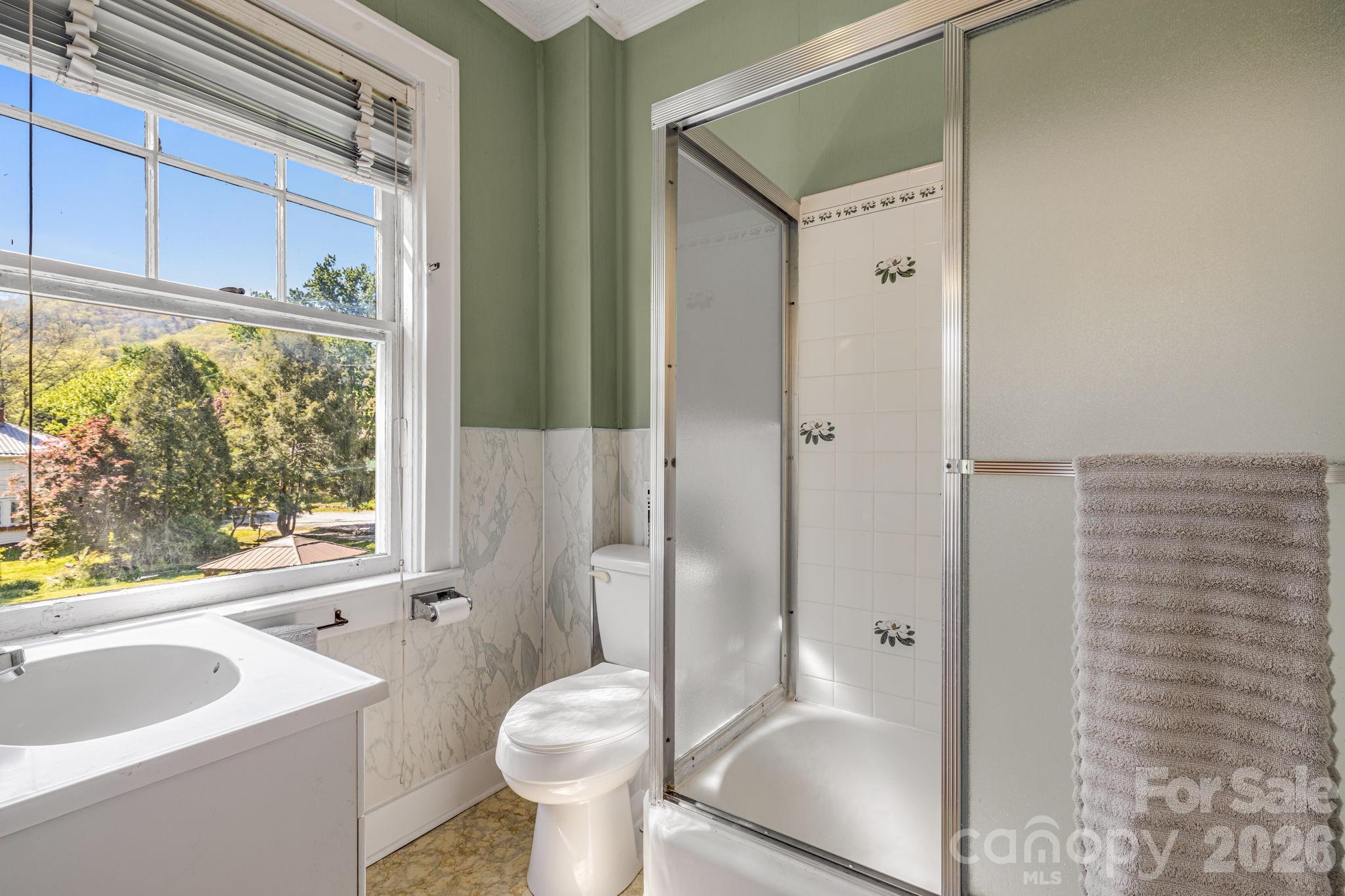 29 Walnut Street Hot Springs, NC 28743 - Photo 26 of 46 a bathroom with a sink toilet and shower