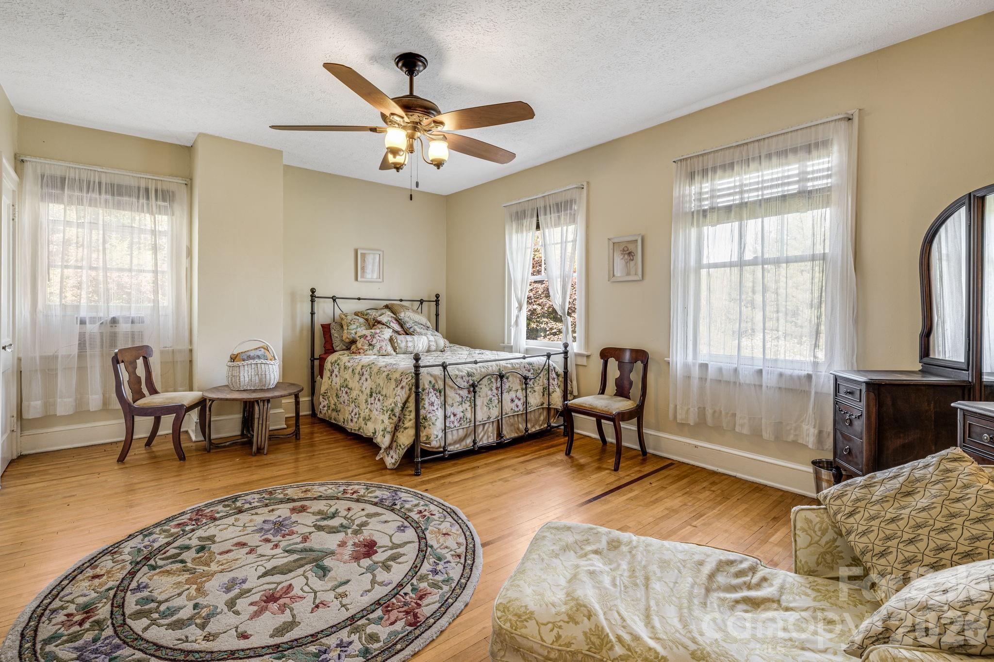 29 Walnut Street Hot Springs, NC 28743 - Photo 31 of 46 a bedroom with a bed and a chandelier