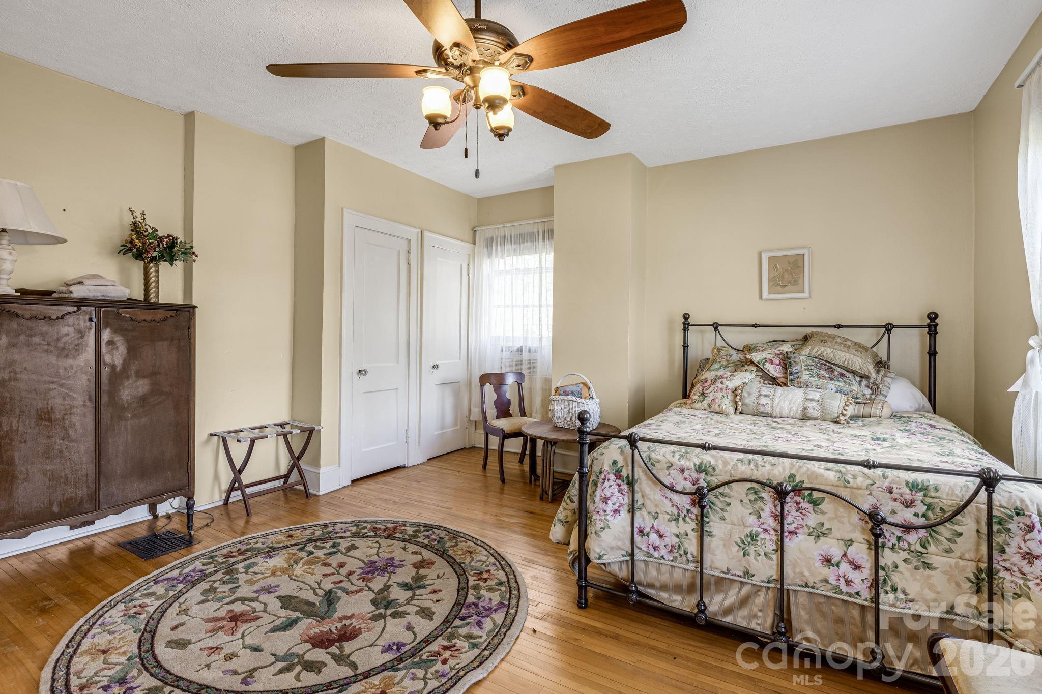 29 Walnut Street Hot Springs, NC 28743 - Photo 33 of 46 a bedroom with a bed and wooden floor