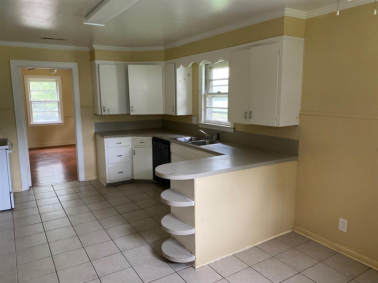 331 East Ripley Avenue Covington, TN 38019 - Photo 2 of 12 Kitchen includes dishwasher and electric stove. Just through the door is the dining room (previously used as a 4th bedroom.)