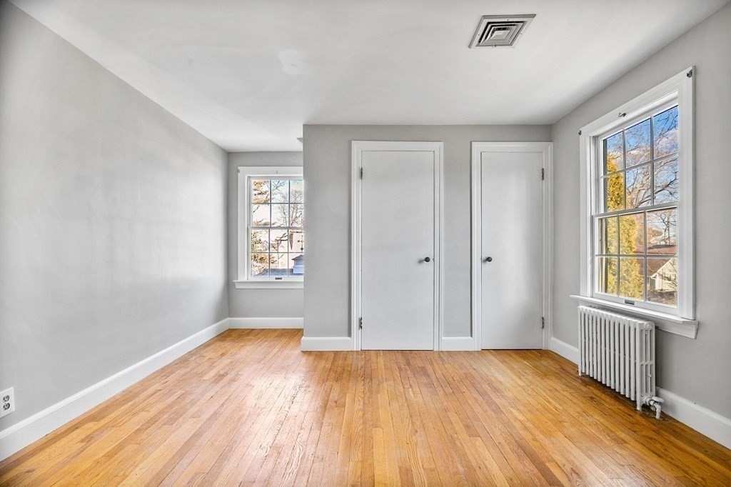 85 Pleasant Circle Canton, MA 02021 - Photo 24 of 35 an empty room with wooden floor and windows