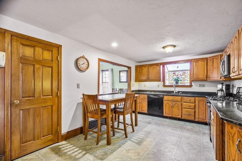 85 Pleasant Circle Canton, MA 02021 - Photo 6 of 35 a kitchen with a refrigerator and a stove top oven