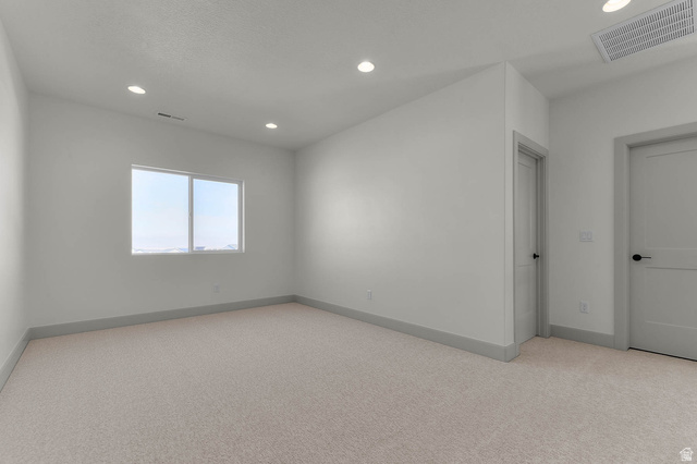 562 West Coyote Rdg Road Grantsville, UT 84029 - Photo 23 of 27 Carpeted room with a double-pane window, recessed lighting, and two interior doors with black hardware
