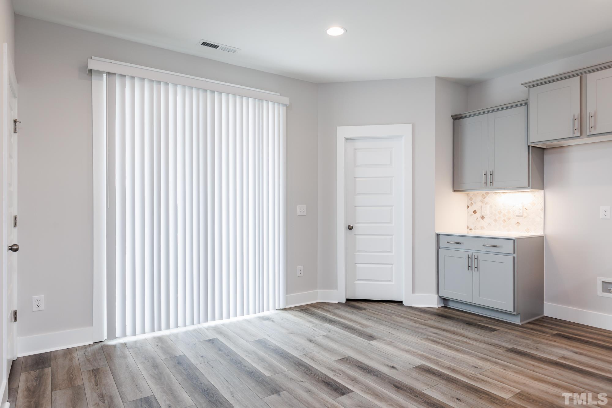 8105 Diversy Way Raleigh, NC 27613 - Photo 4 of 9 a view of a kitchen with wooden floor and a sink