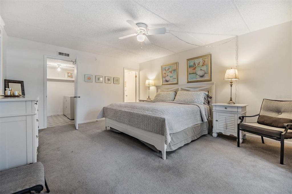 12760 Indian Rocks Road, Unit 104 Largo, FL 33774 - Photo 15 of 37 a bedroom with a bed and a chandelier