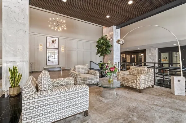 a living room with furniture and flowers