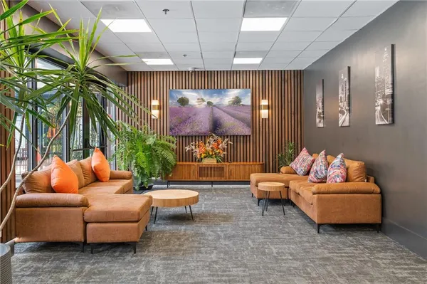 a living room with furniture and a potted plant