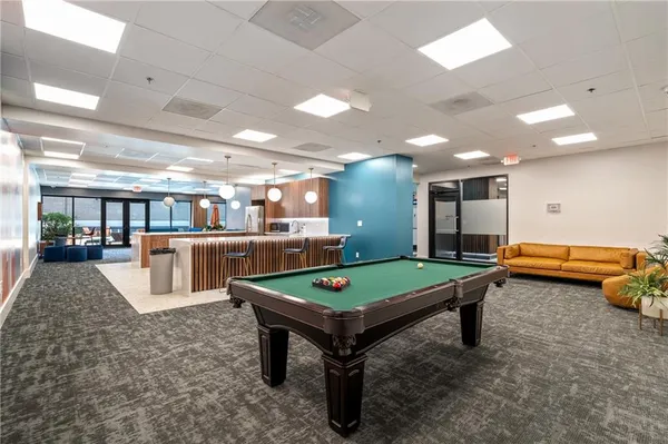 a room with furniture and pool table
