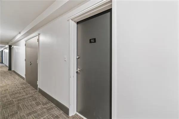 a view of a hallway with closet and wooden floor