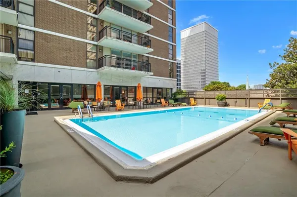 a view of a building with cars parked in front of it