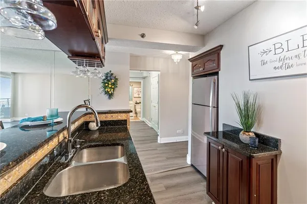 a kitchen with sink refrigerator and stove
