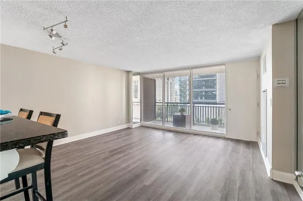 a view of a room with wooden floor and windows