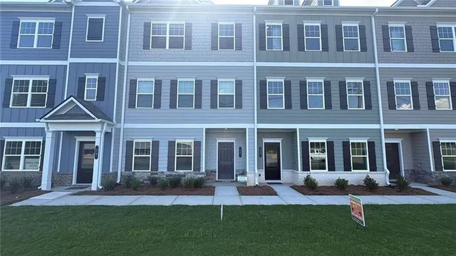 a front view of a building with a yard