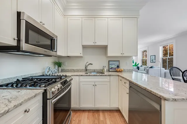 a kitchen with stainless steel appliances granite countertop a sink stove and microwave