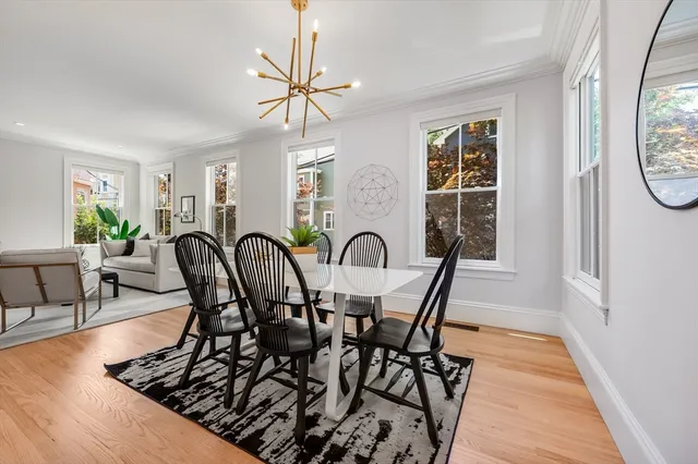 a view of a dining room with furniture and chandelier
