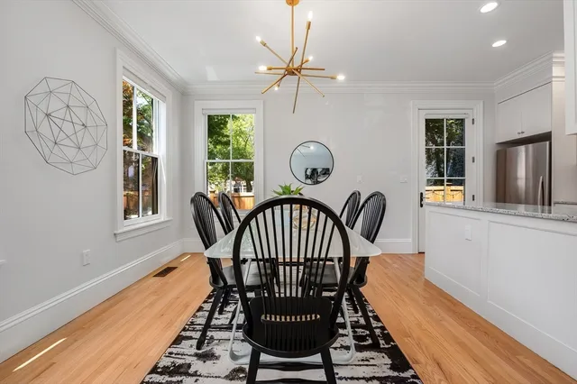 a view of a dining room with furniture window and wooden floor