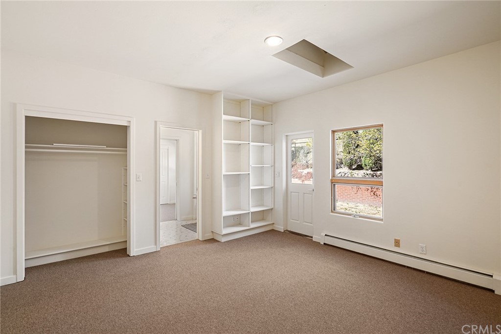 95 Hiller Drive Oakland, CA 94618 - Photo 28 of 58 Bedroom #2 main floor with skylight and built in bookshelves