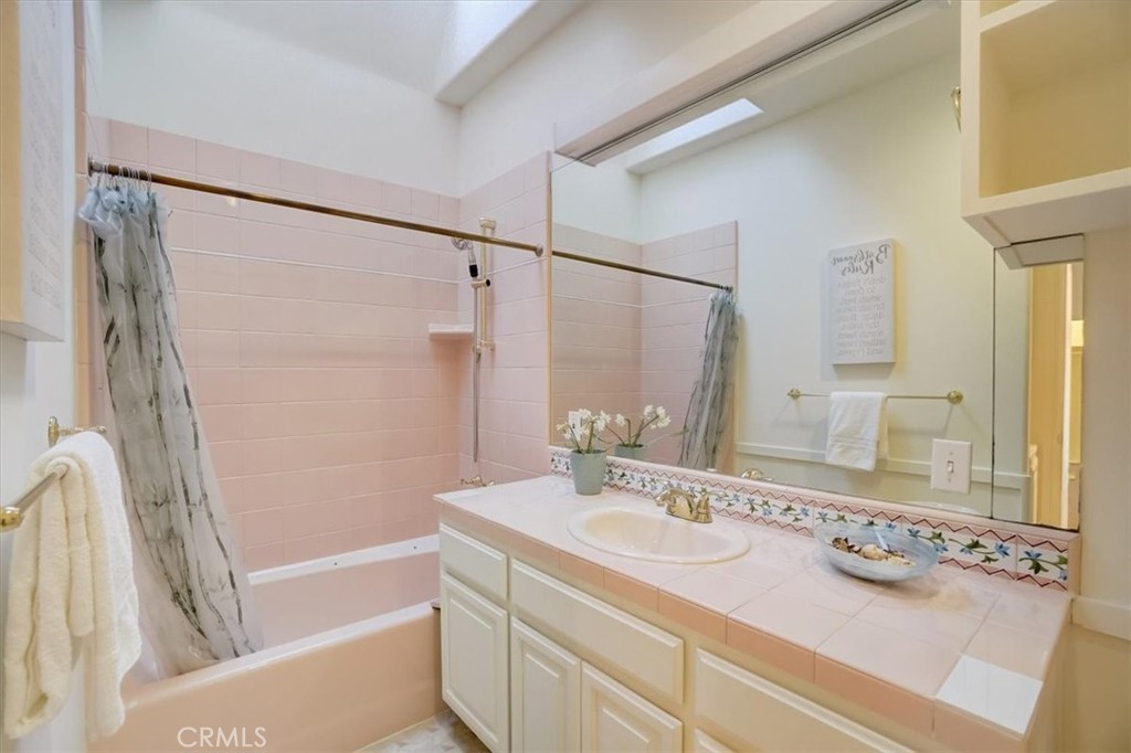 95 Hiller Drive Oakland, CA 94618 - Photo 29 of 58 a bathroom with a tub sink and mirror