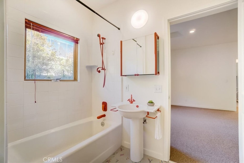 95 Hiller Drive Oakland, CA 94618 - Photo 32 of 58 a bathroom with a tub sink and mirror