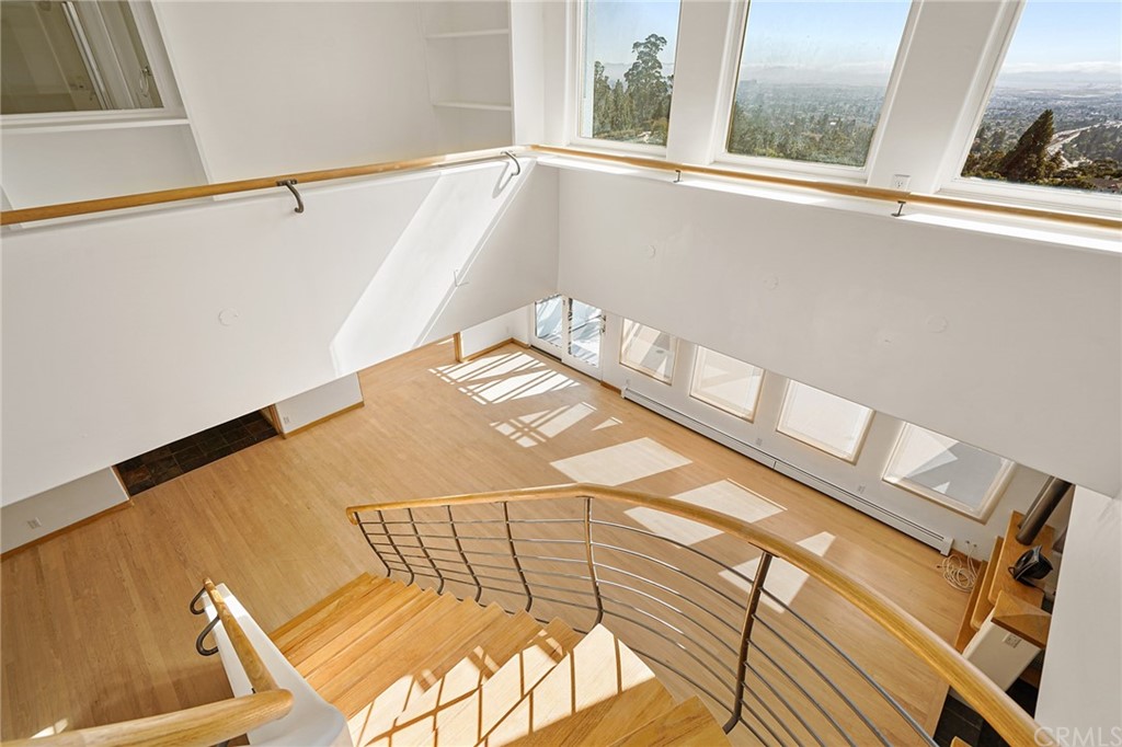 95 Hiller Drive Oakland, CA 94618 - Photo 38 of 58 View looking down from staircase to main floor living and dining areas