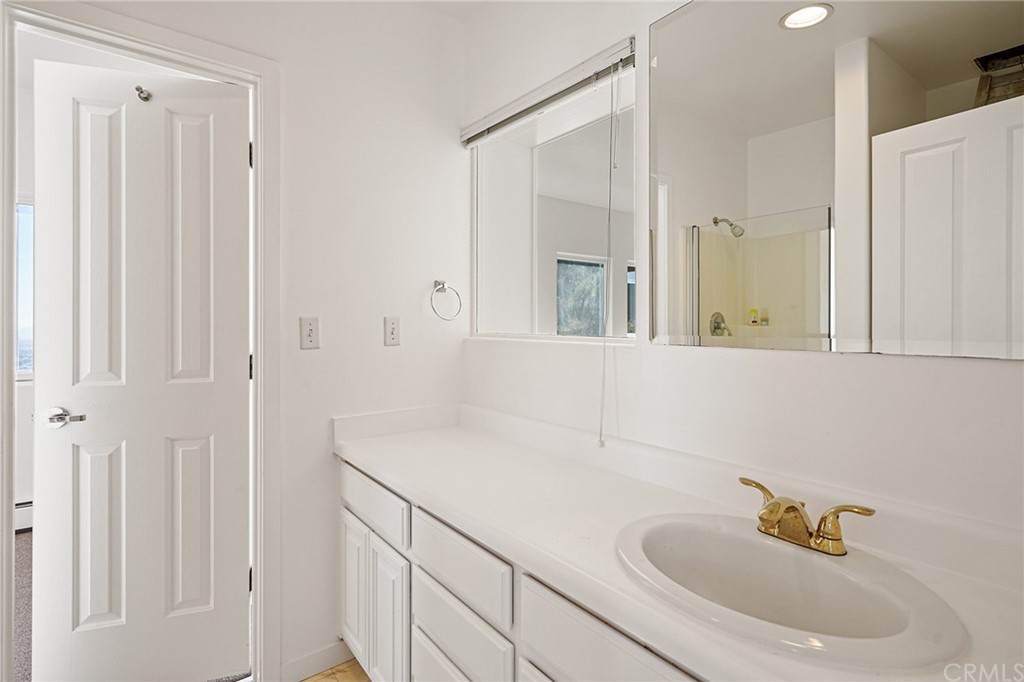 95 Hiller Drive Oakland, CA 94618 - Photo 42 of 58 a bathroom with a sink and a mirror