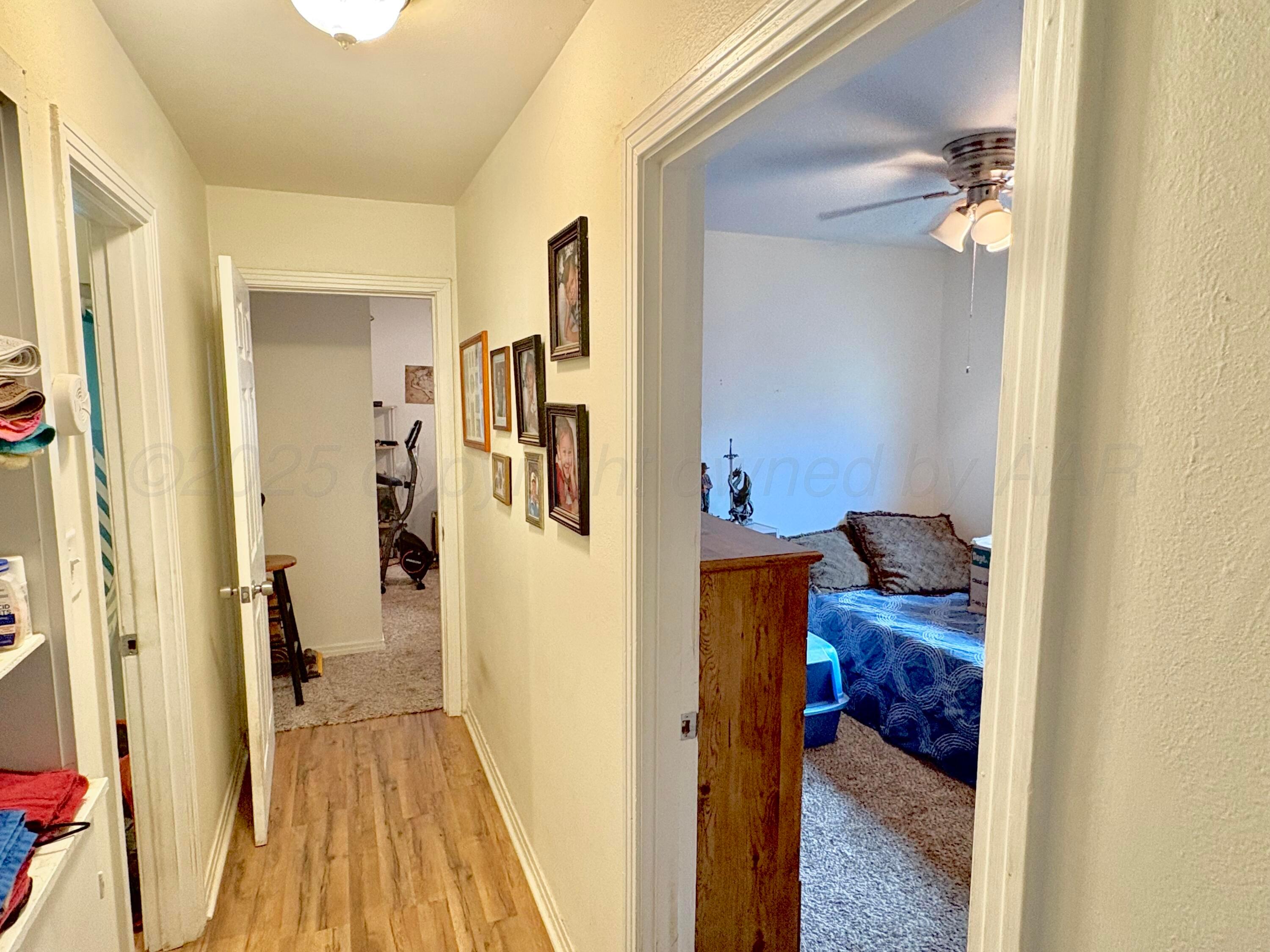4405 South Lipscomb Street Amarillo, TX 79110 - Photo 6 of 9 a view of a bedroom from a hallway
