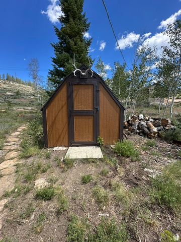 1085 West Elk Road Helper, UT 84526 - Photo 31 of 40 Gable-roofed shed with textured brown siding and dark trim