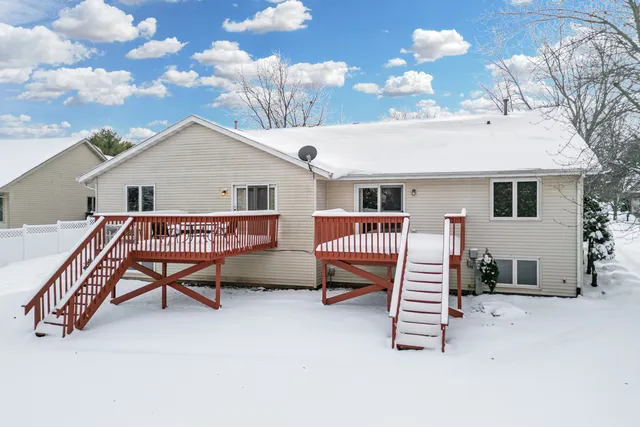 a backyard of a house with barbeque oven table and chairs
