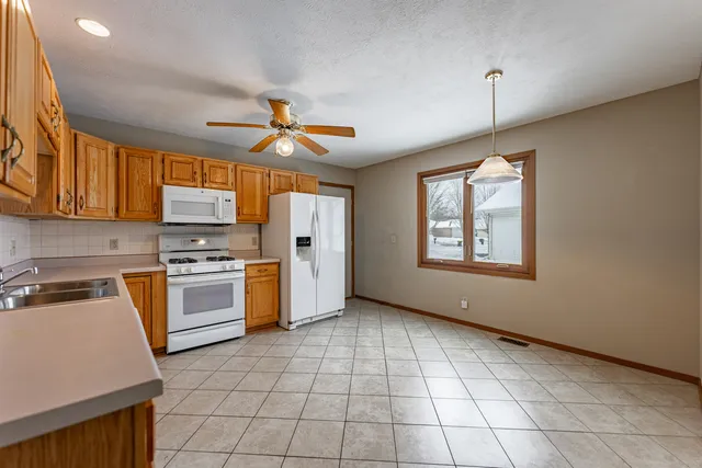 a kitchen with a stove a sink and a refrigerator