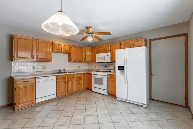 a kitchen with a stove a sink and a refrigerator