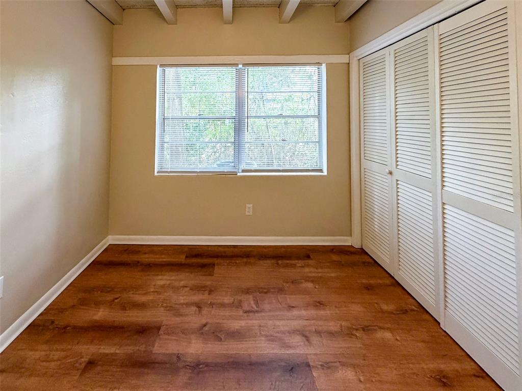 219 Northwest 3rd Avenue, Unit B Gainesville, FL 32601 - Photo 15 of 20 an empty room with wooden floor and windows