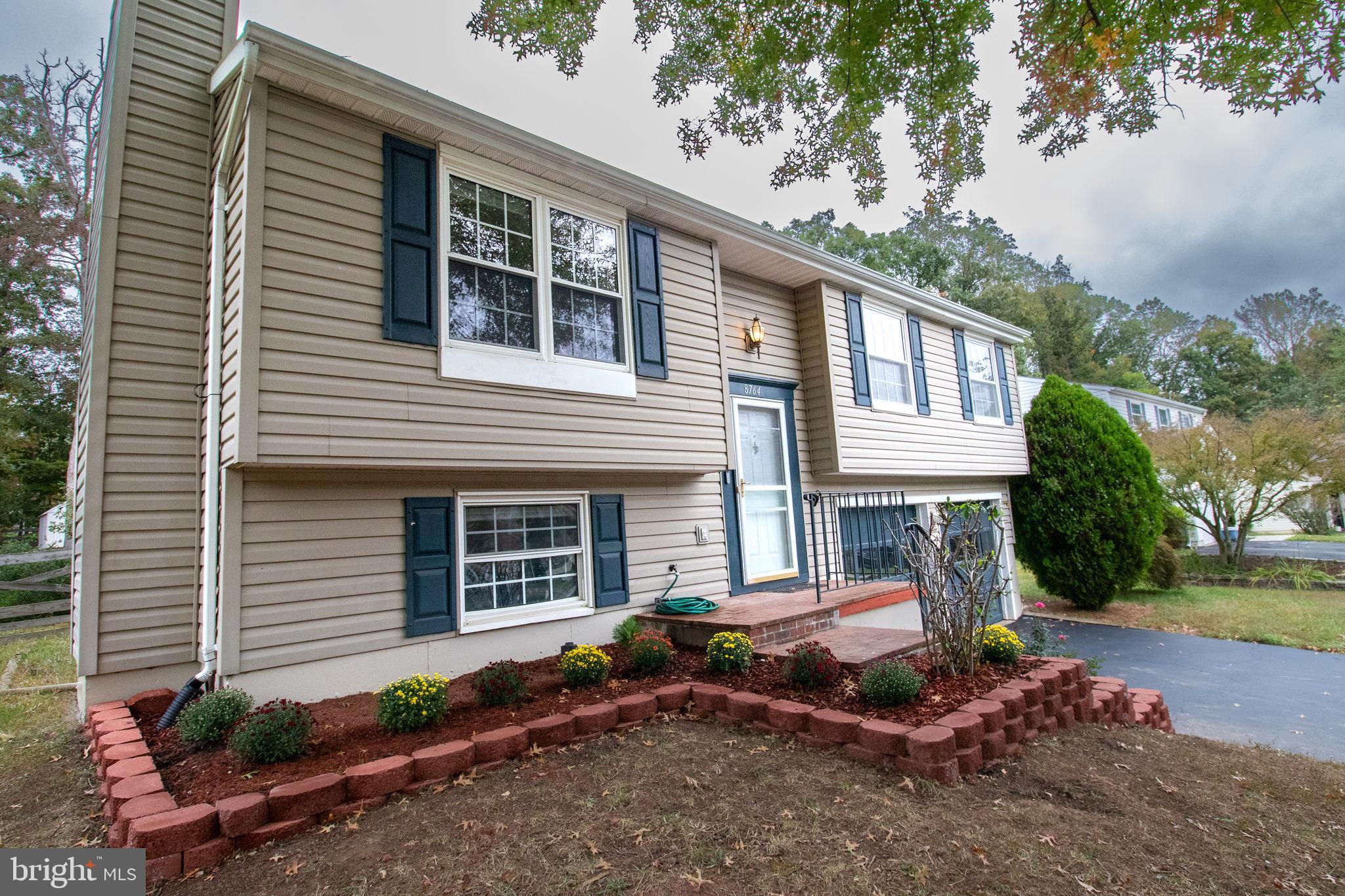 8764 Cold Plain Court Springfield, VA 22153 - Photo 1 of 24 a front view of a house with a yard and outdoor seating