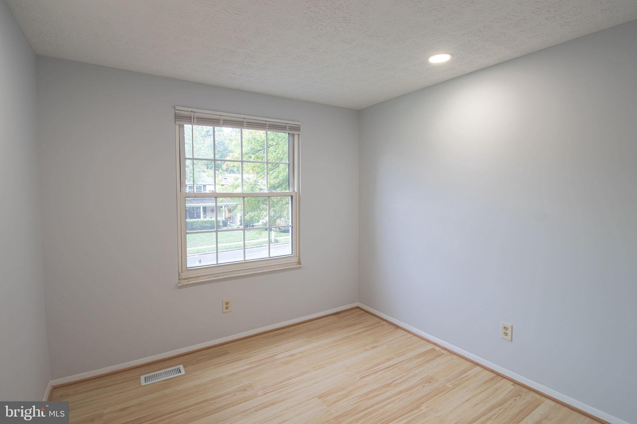 8764 Cold Plain Court Springfield, VA 22153 - Photo 11 of 24 an empty room with wooden floor and windows