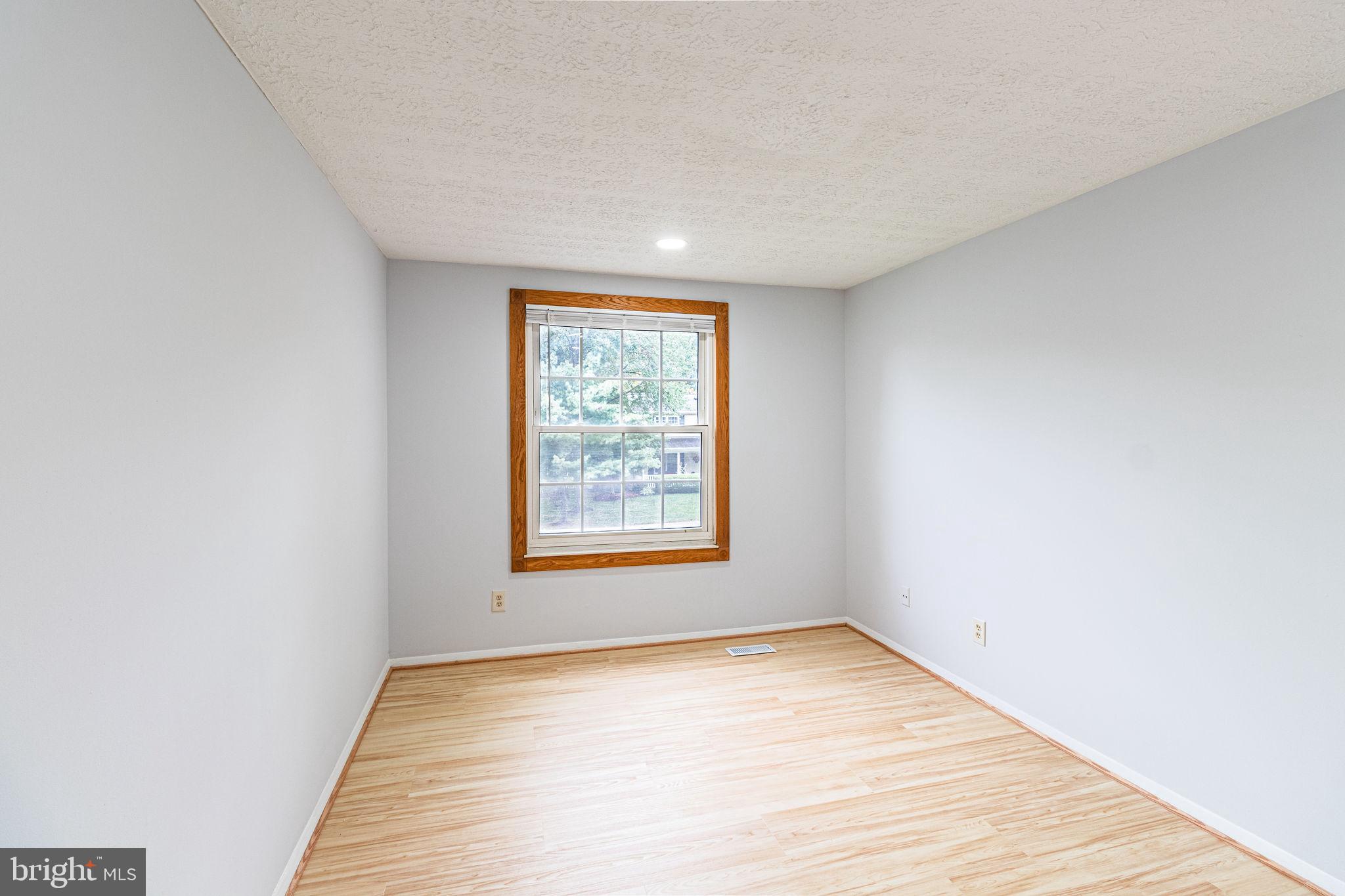 8764 Cold Plain Court Springfield, VA 22153 - Photo 13 of 24 an empty room with wooden floor and windows