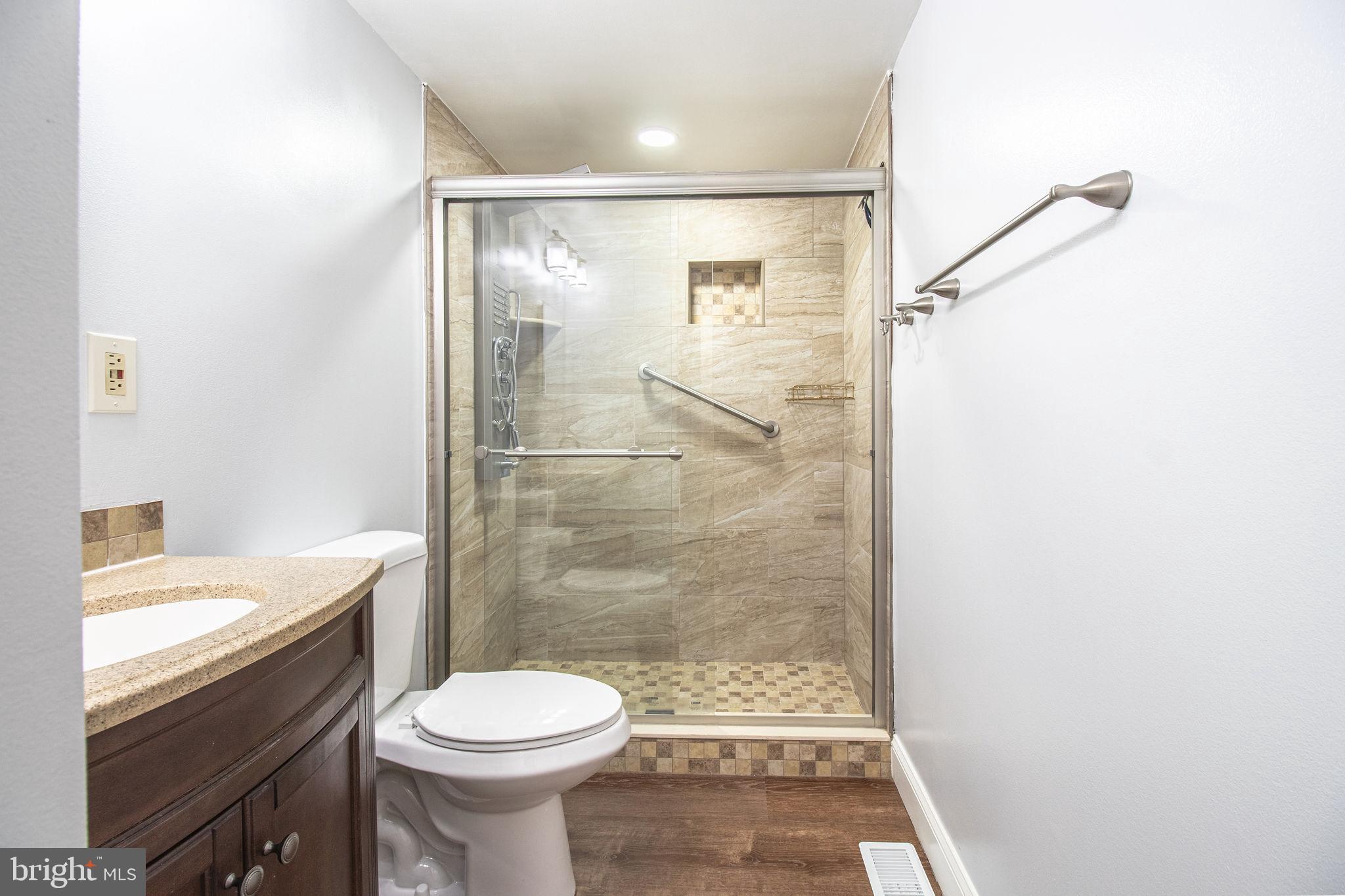 8764 Cold Plain Court Springfield, VA 22153 - Photo 14 of 24 a bathroom with a sink toilet and shower