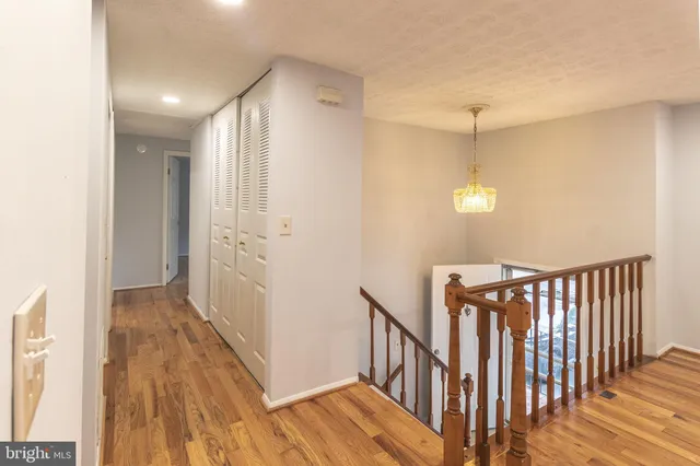 a view of hallway with wooden floor