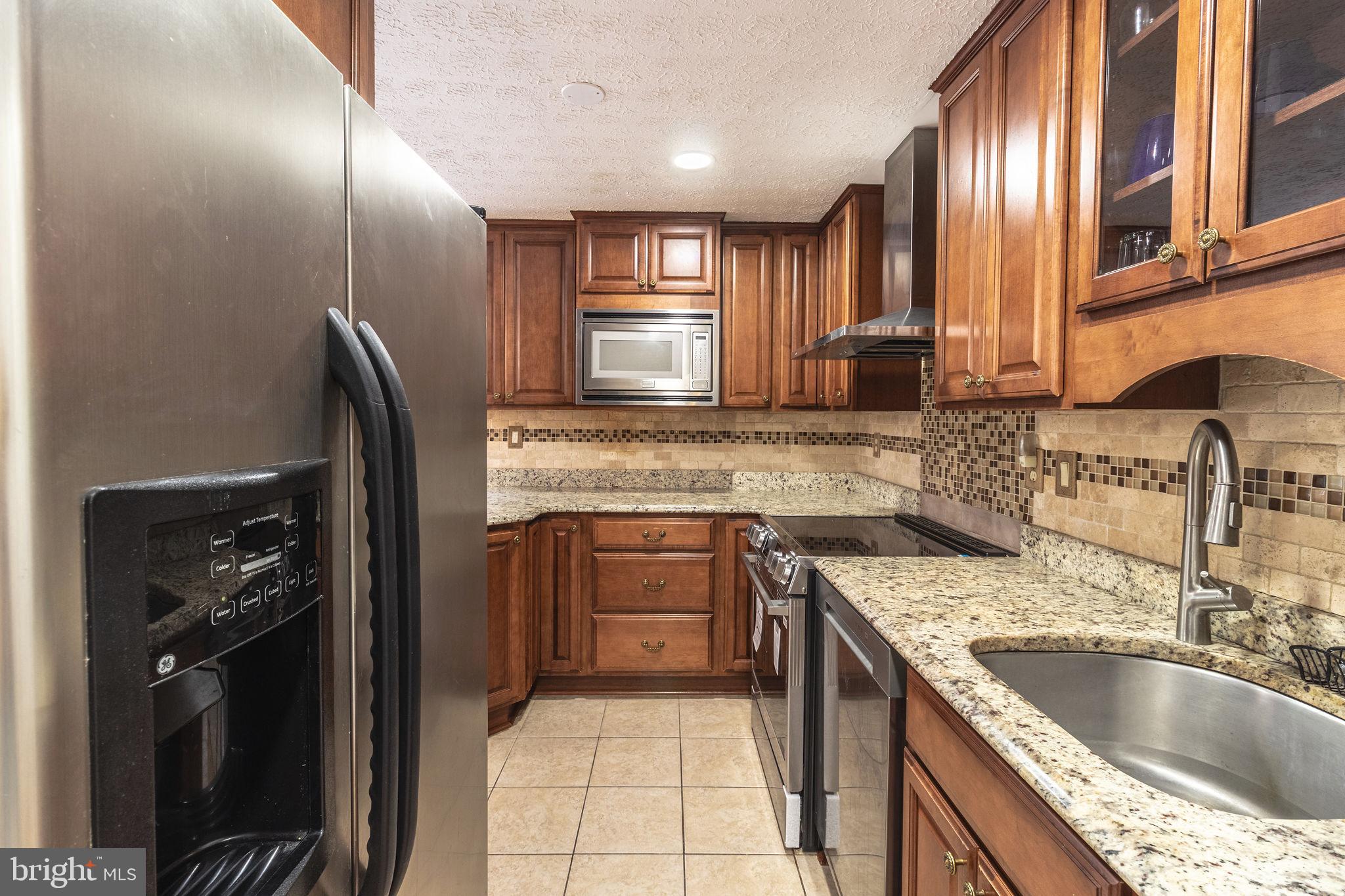 8764 Cold Plain Court Springfield, VA 22153 - Photo 7 of 24 a kitchen with a sink stove and refrigerator