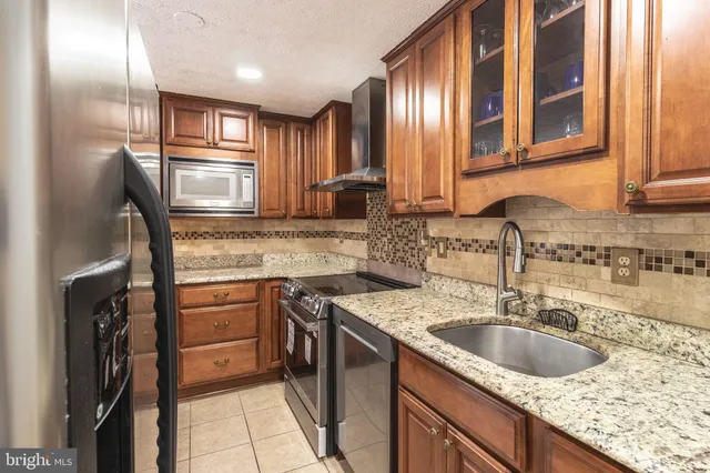a kitchen with a sink stove and refrigerator