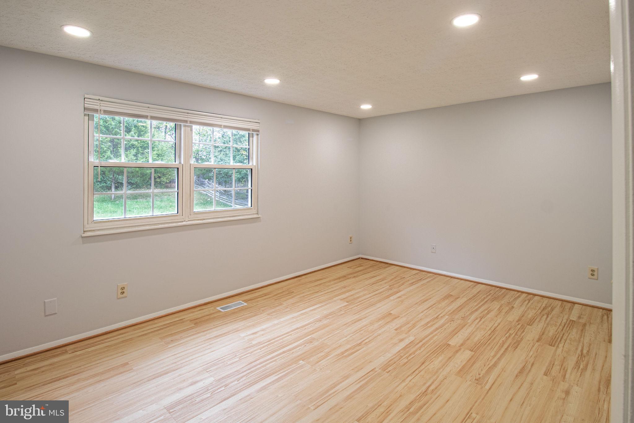 8764 Cold Plain Court Springfield, VA 22153 - Photo 9 of 24 an empty room with wooden floor and windows