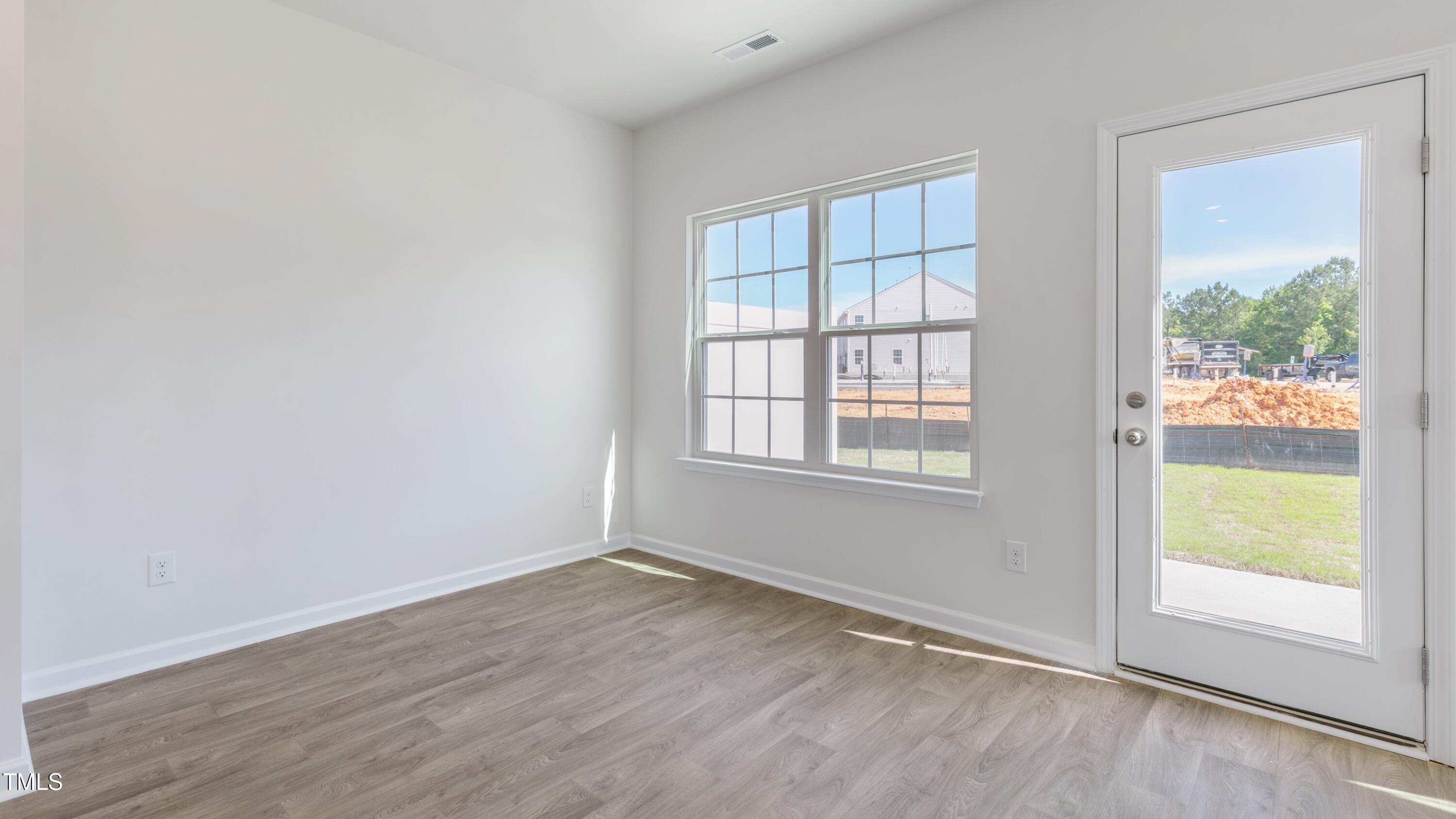55 Virgo Drive Angier, NC 27501 - Photo 13 of 31 an empty room with wooden floor and windows