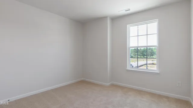an empty room with windows and cabinet
