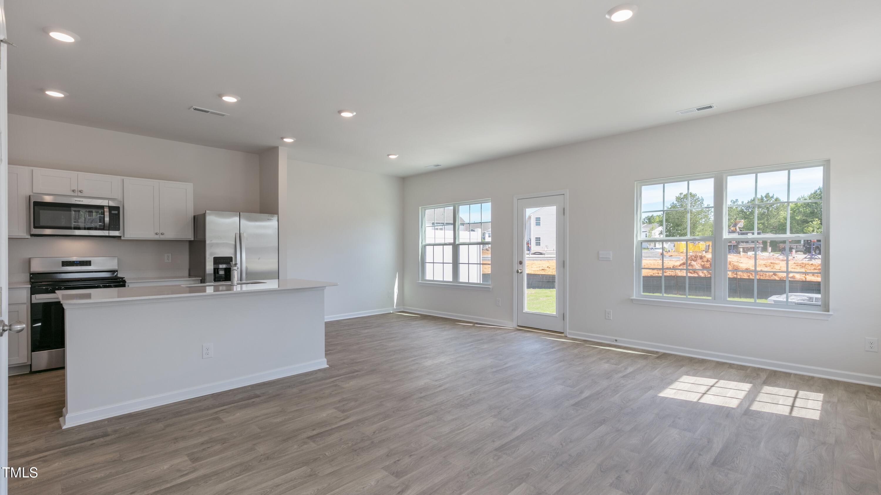 55 Virgo Drive Angier, NC 27501 - Photo 4 of 31 a kitchen with stainless steel appliances a refrigerator sink and stove top oven
