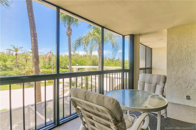 a view of a dining room with furniture large window and wooden floor
