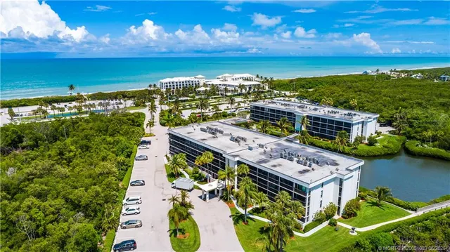 an aerial view of a house with a lake view