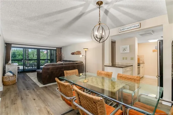 a view of a dining room with furniture wooden floor and chandelier