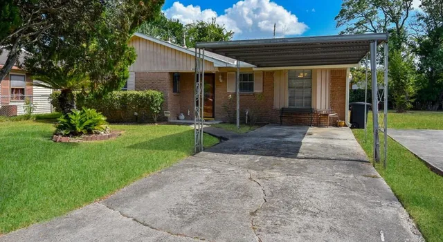 a front view of house with a garden