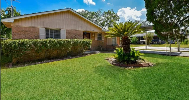 a front view of a house with garden