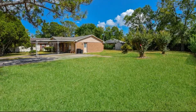 a front view of house with yard and green space