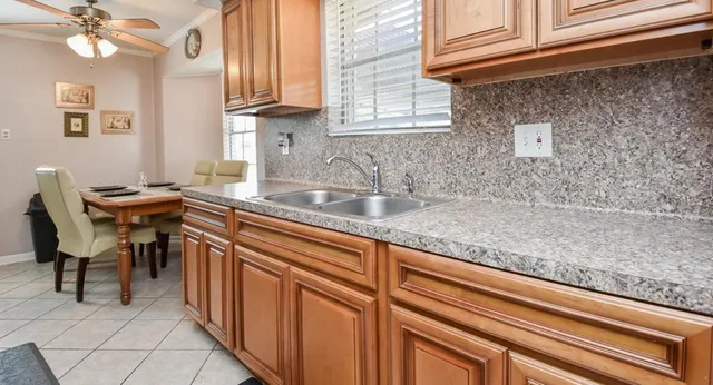 a kitchen with a sink cabinets and appliances